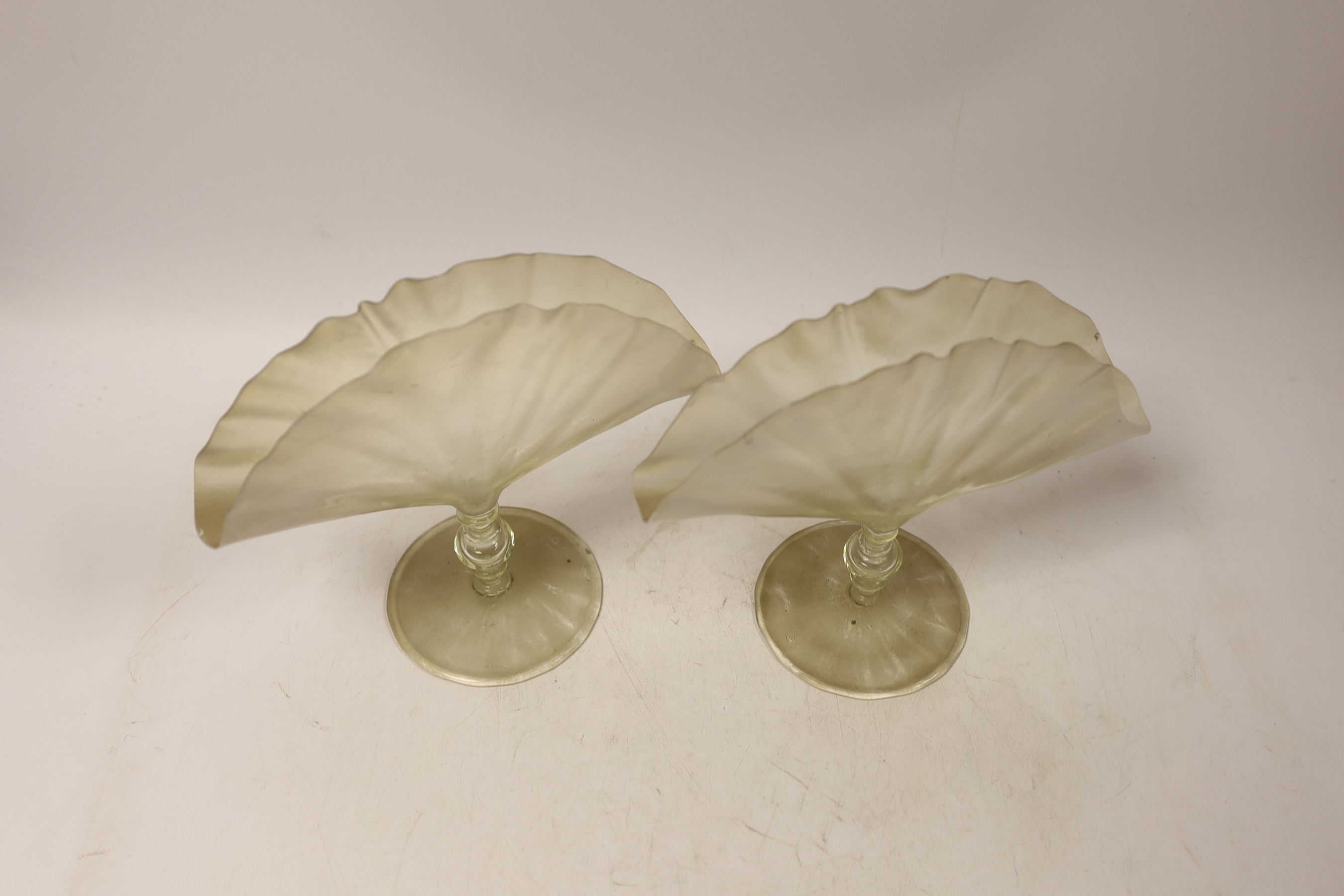 A pair of late 19th century vaseline glass fan shaped napkin holders on single knop stems, 16.5cm high x 19cm wide